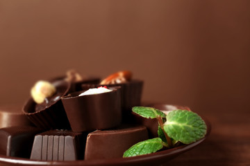 Plate with delicious chocolate  candies, closeup