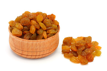 Organic dried Raisins in wood plate isolated on white background