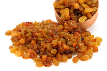 Organic dried Raisins in wood plate isolated on white background