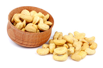 cashew in wood plate isolated on white background