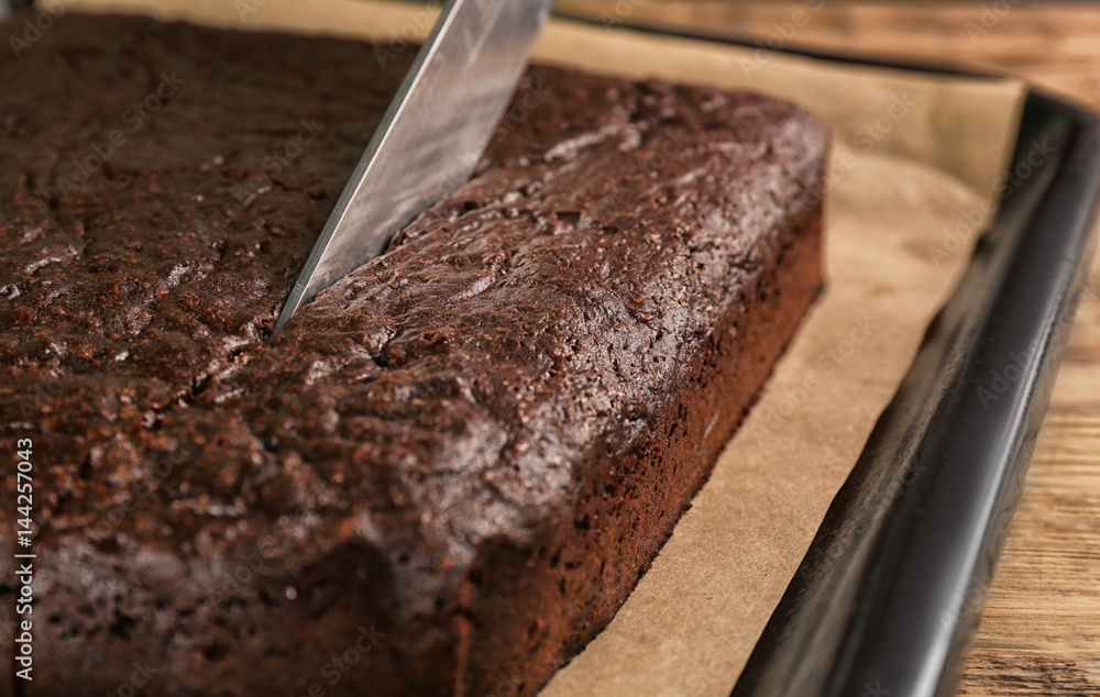 Sticker cutting of delicious chocolate brownie on baking tray