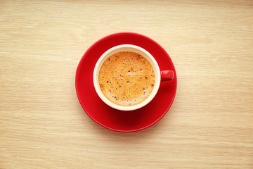 Cup of hot coffee on wooden table