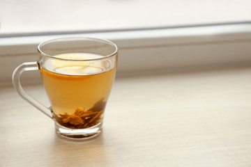 Cup of hot tea on window sill