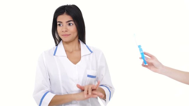 Young woman nurse is afraid and refusing of syringe isolated
