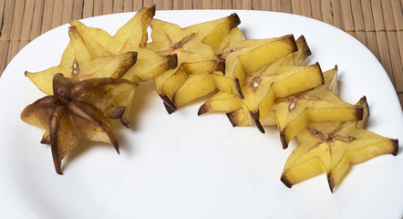 Slices of carambola isolated on a white plate