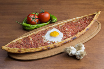 Turkish round and flat bread with minced meat egg