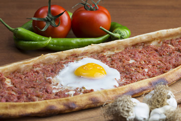 Turkish round and flat bread with minced meat egg
