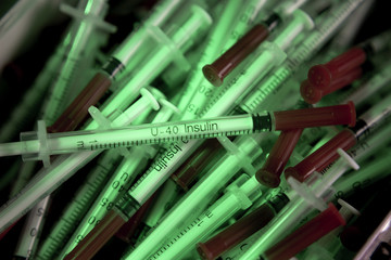 Syringes on colorful background unfocused