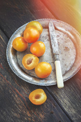 Yellow mirabelle plums in rustic metal dish