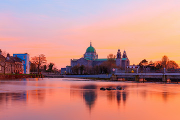 Cathedral on the bank of the river during sunset