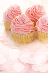 Vanilla cupcakes with pink raspberry frosting