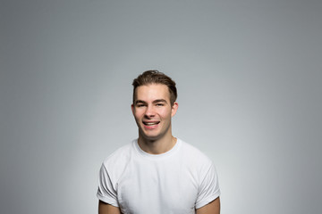 Studio portrait of a laughing young man