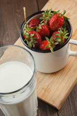 Ripe strawberries in an enamel cup
