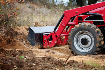 Tractor front end loader with dirt on construction side