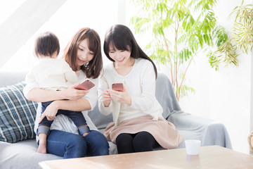 young asian family using smart phone in living room