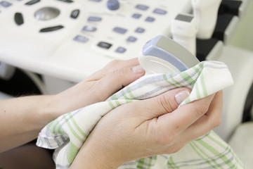 Sensors of the uzi apparatus are wiped by the nurse, medical equipment, physician's hands