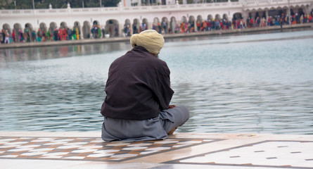 Old Sikh prays near the Golden temple