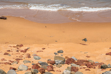 Fototapeta na wymiar Stony beach in Goa, India, on a sunny day
