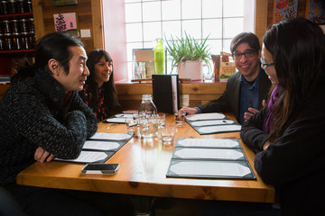 Group of ethnic people dining at a restaurant