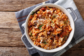 Baked pasta with tomato, bacon and cheese close-up. horizontal top view