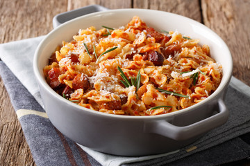 Spicy baked pasta with tomato, bacon and Parmesan cheese close-up. horizontal