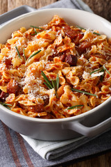 Italian pasta with tomato, bacon and Parmesan cheese close-up. vertical