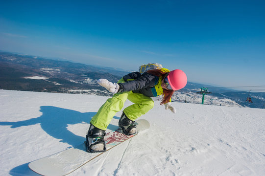 snowboarder in yellow clothes resting on the mountain