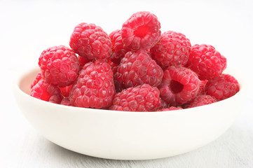 Raspberries in white bowl