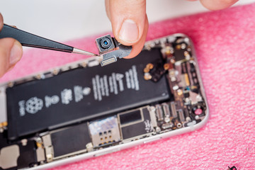 Repairing Damaged Smart Phone in service center. closeup