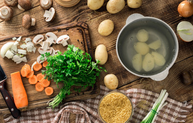 Ingredients for cooking vegetarian soup on a wooden table