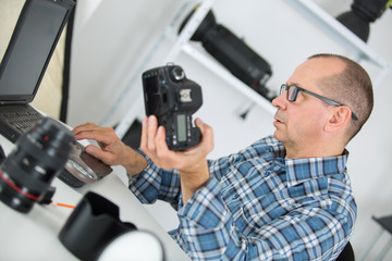 technician examining and repairing dslr camera