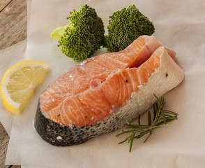 salmon raw. salmon red fish steak with herbs and lemon isolated on a white background