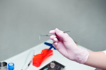 Dentist doctor hand holding medical tools in dental office. Concept of healthy