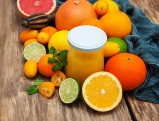 Jar of juice and fresh citrus fruits