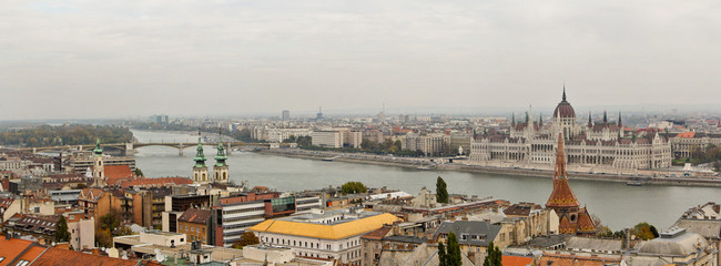 Panoramic overview of Budapest with Parliament building. Photo was made on the Buda part with Fisherman's Bastion through stones windows