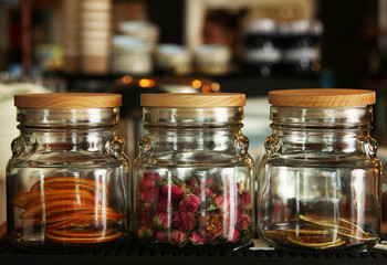 glass jars with dried flowers and oranges