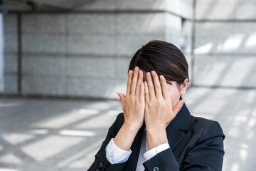 woman covering her face