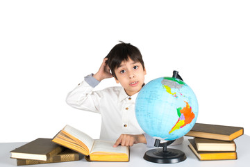 the boy studies the globe and reads the book.