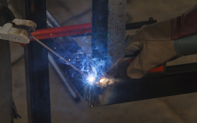 Shield metal arc welding welding and C-clamp in fabrication work shop. - obrazy, fototapety, plakaty
