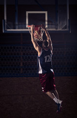 basketball player slam dunk, in air