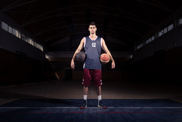 Naklejka premium basketball player two balls posing