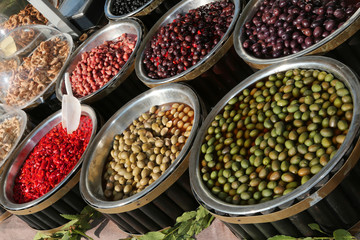 Italian market stall with olives and red peppers for sale