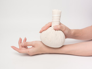 Obraz na płótnie Canvas Aromatherapy product Spa massage set hold by hand with white background .