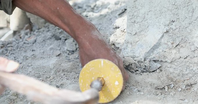 Unidentified Man with the drill breaking up asphalt on the road.