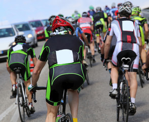 group of cyclists cycling during the race on the road