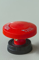 Red emergency stop and reset button on control panel for machine control.