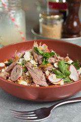 Roasted organic leg of lamb salad, served with radish, quinoa and feta cheese.