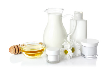 Honey, milk and cosmetics on white background
