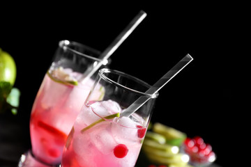 Refreshing cocktails with cranberry on dark background
