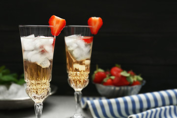 Refreshing cocktails with strawberry on gray table